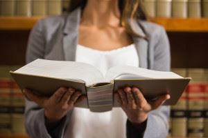 female holding an open book