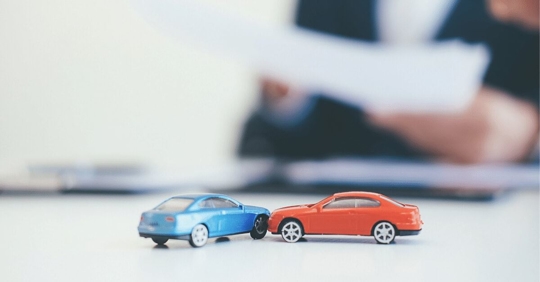 toy vehicles on desk of insurance adjuster