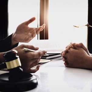 People talking with a gavel on a table
