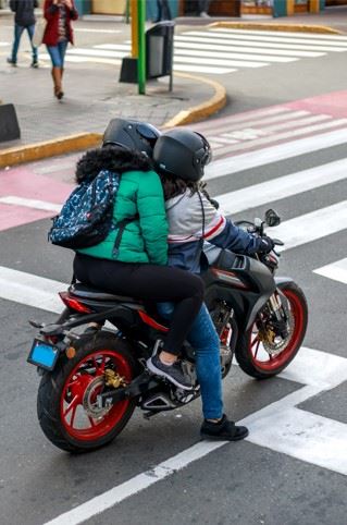 a couple riding on a motorcycle in new york