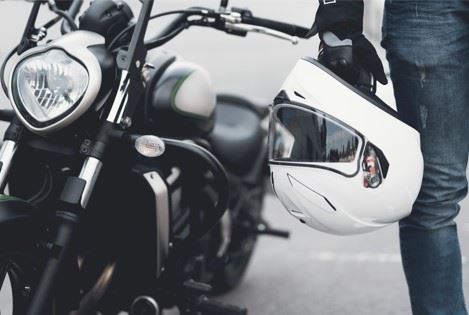 biker holding motorcycle helmet