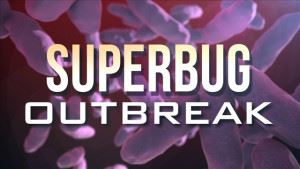 Superbug Outbreak text over bacteria illustration