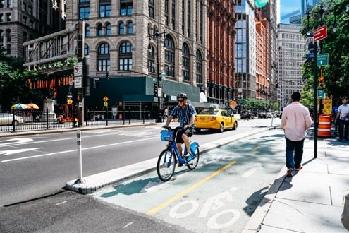 cyclist riding in new york city bike lane