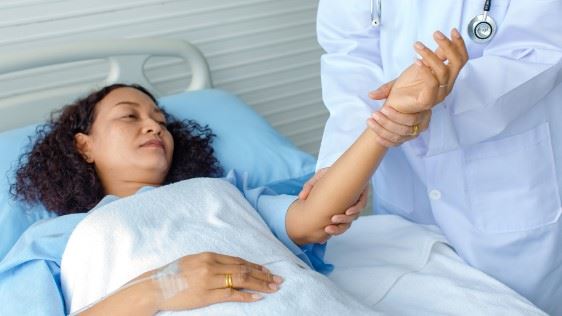 doctor checking a womans blood pressure